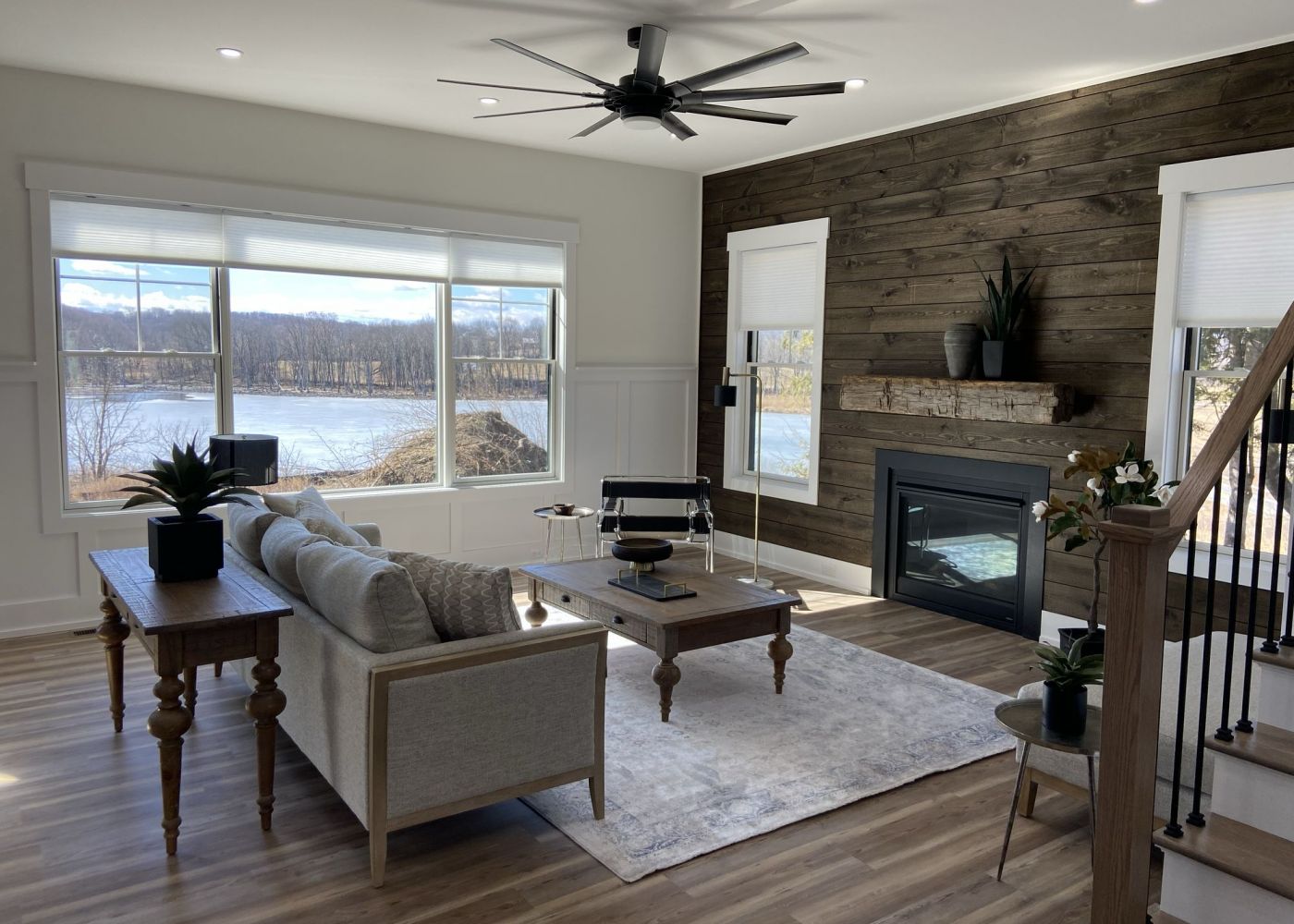Mountain Crest Reserve rental home living room with large fireplace and sweeping view of lake and
