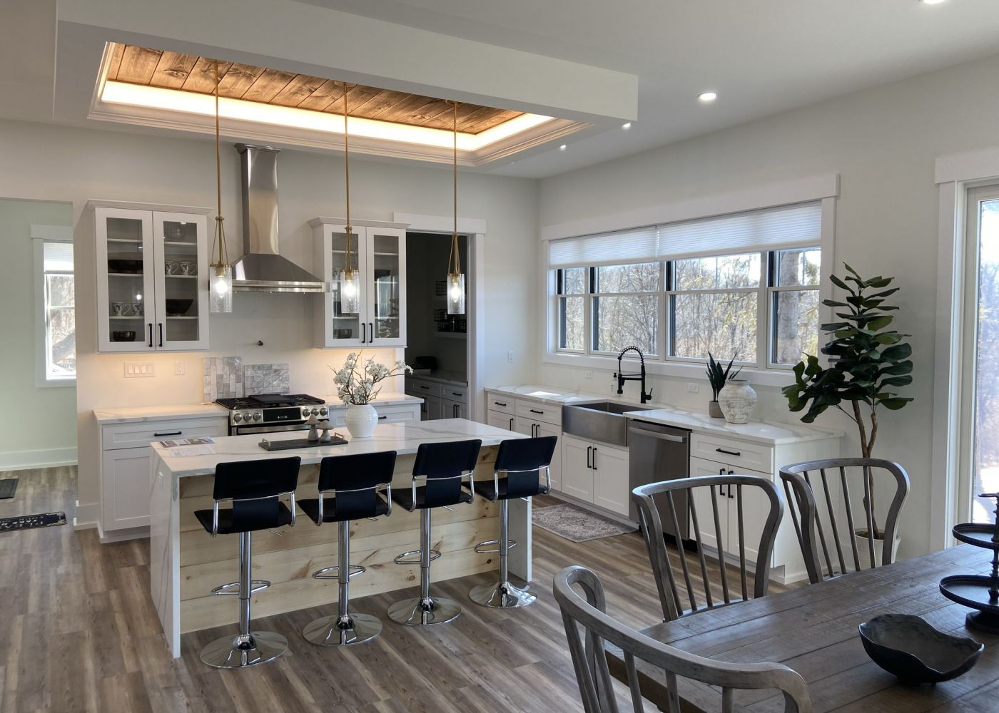 Mountain Crest Reserve kitchen and living room home interior with wood flooring, large windows, and high-end finishes