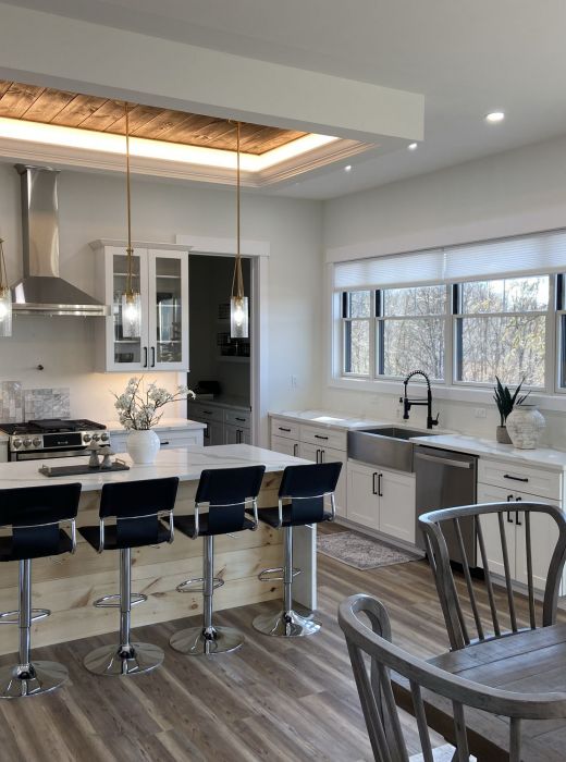 Mountain Crest Reserve kitchen and living room home interior with wood flooring, large windows, and high-end finishes